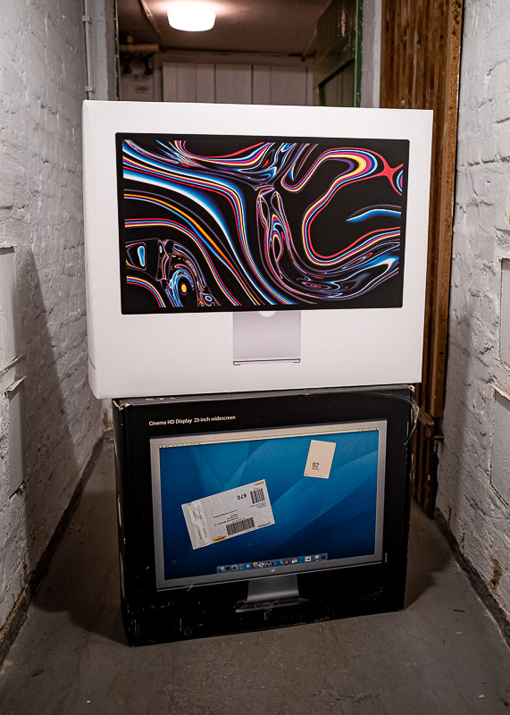 A box of the Apple studio display on top of the box of Apple's Cinema Display.