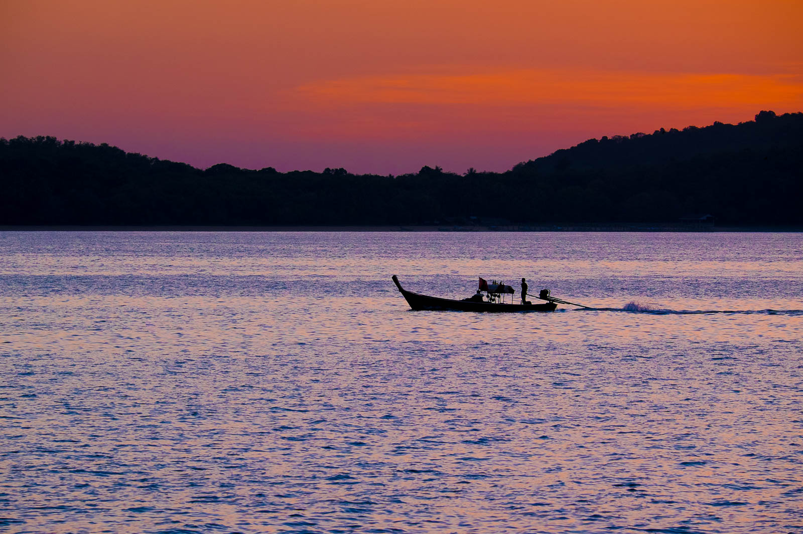 A lonely boat during sunrise on Ko Lanta, Thailand