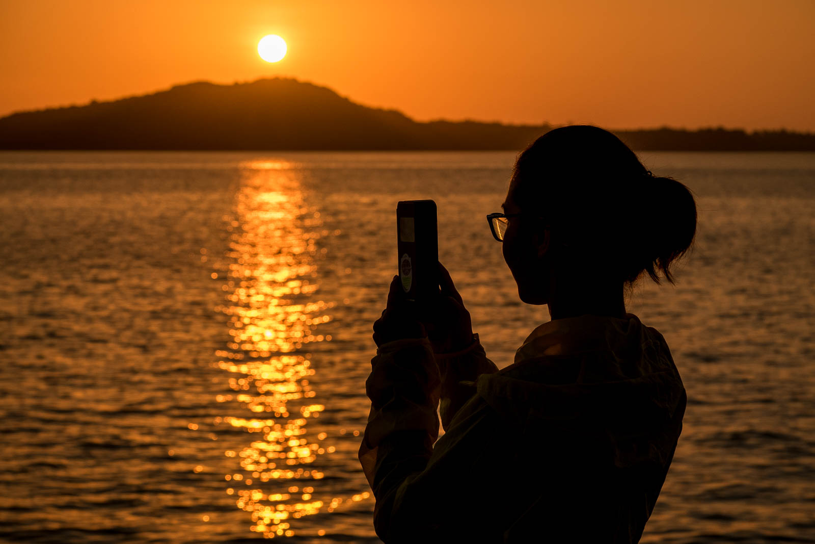 Taking a picture during sunrise on Ko Lanta, Thailand