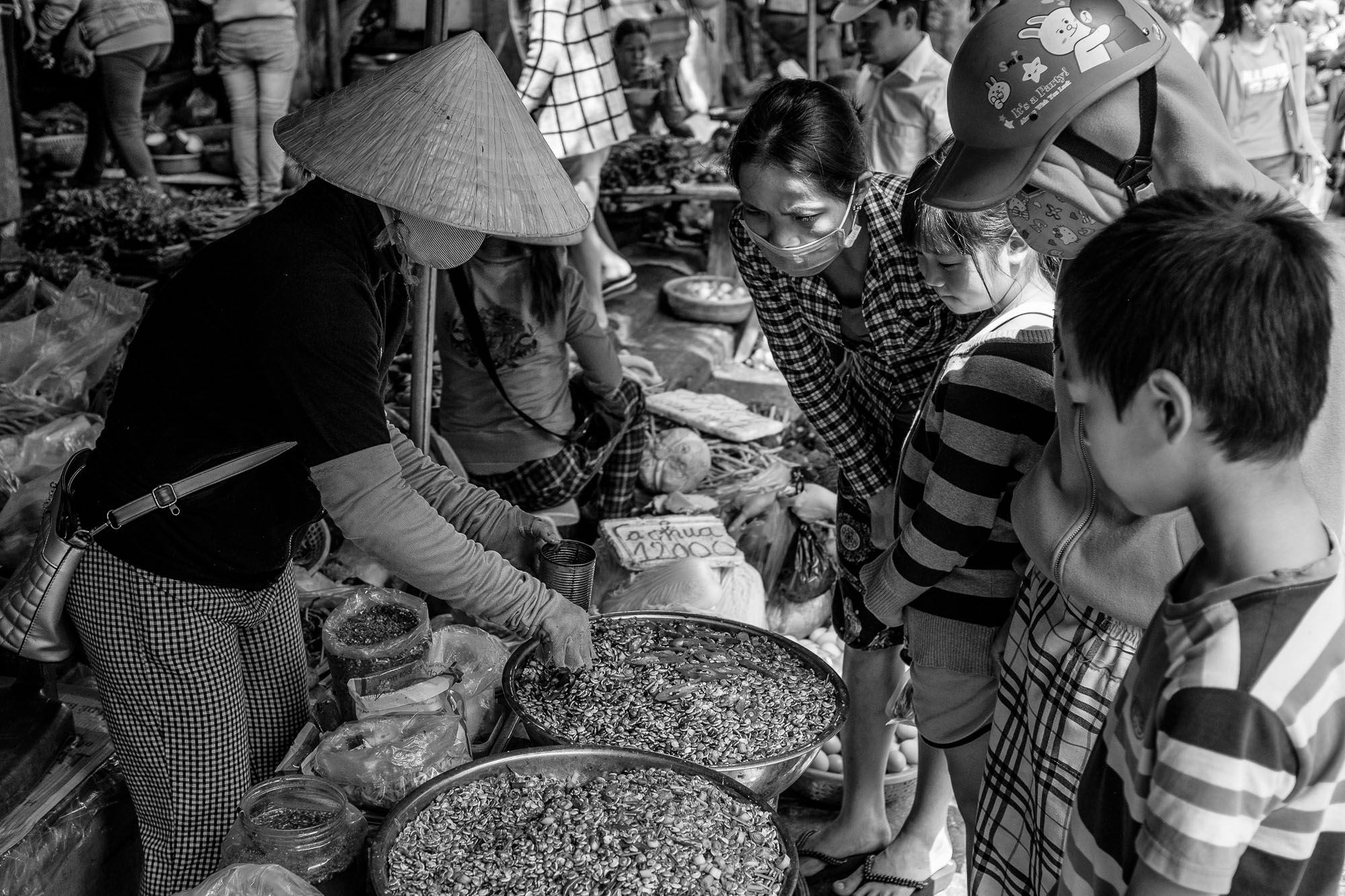 Customers examine the goods of a vendor